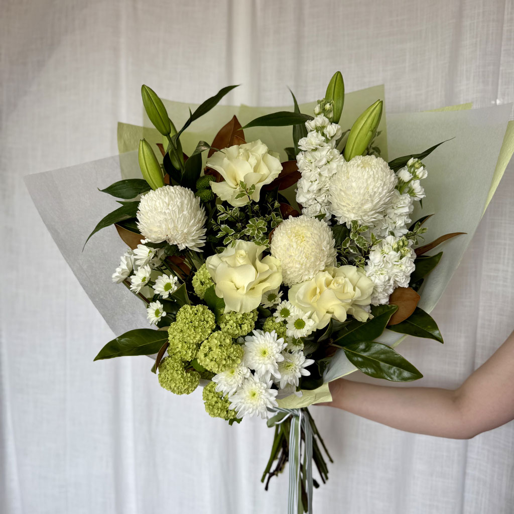 Sympathy flower arrangement in soft, elegant tones